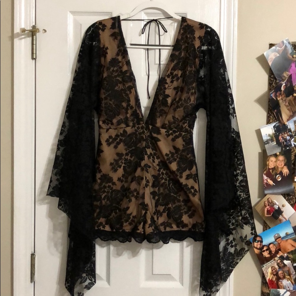 Black lace romper with low cut v neck and tie